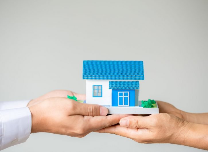 Real estate broker agent presenting and consult to customer to d Real estate broker agent presenting and consult to customer to decision making sign insurance form agreement, home model, concerning mortgage loan offer for and house insurance.